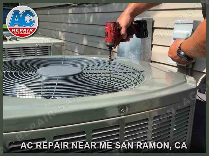 AC Repair San Ramon technician replacing fan housing on outdoor air conditioning unit.