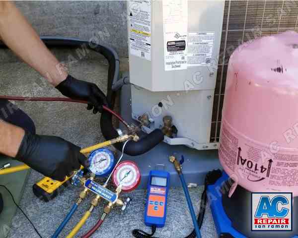 The image shows our skilled technician diagnosing and repairing a malfunctioning air conditioning unit in San Ramon, CA. The technician, equipped with professional tools, is seen meticulously examining the internal components of the AC unit to identify the issue. After a successful diagnosis, he repaired the unit, demonstrating expertise in handling complex HVAC systems. The technician also checks the Freon levels to ensure optimal air conditioner performance. This image links to our air conditioning repair service page, where visitors can find more information about our expert services in San Ramon, CA.