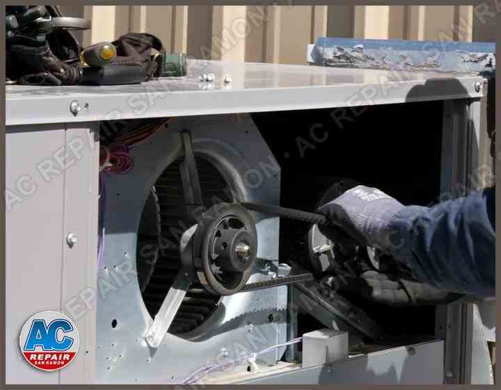 Our AC Repair San Ramon technician is adjusting the belt on the motor's pulley, to reduce the squealing noises.