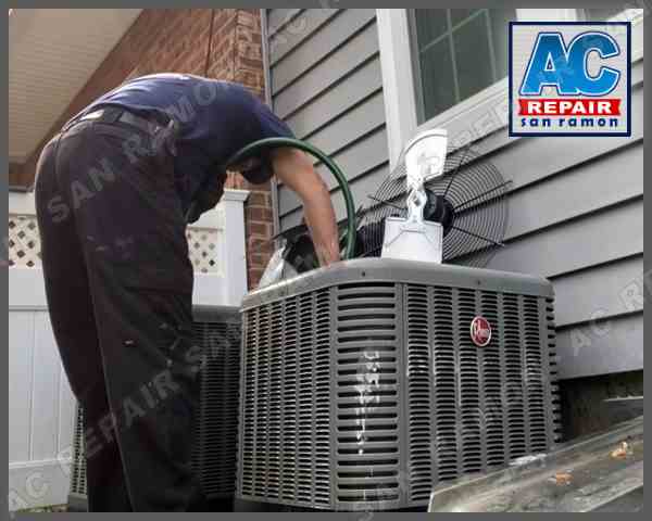 HVAC technician from AC Repair San Ramon performing maintenance on an outdoor air conditioning unit in San Ramon, California