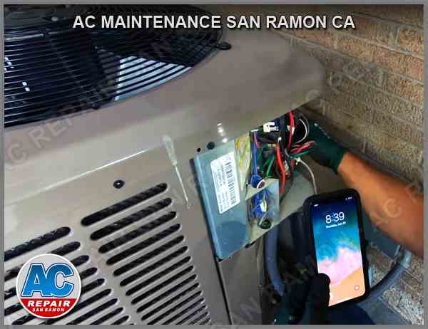 HVAC professional from AC Maintenance San Ramon CA performing detailed maintenance on an air conditioning unit, consulting a digital manual on a smartphone for technical guidance.